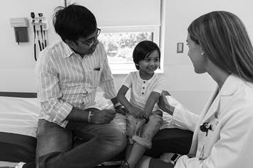 Parent and child in emergency room with doctor