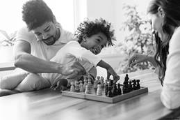 Family of 3 playing chess