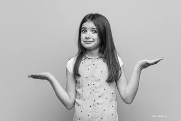 Little girl shrugging