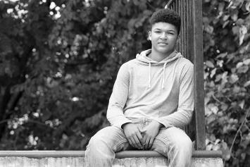 Teenage Boy Sitting Outdoors