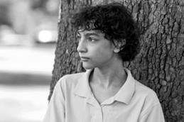 Preteen Boy Leaning on Tree