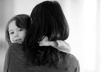 Son Looking Over Mom's Shoulder