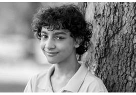 Pre Teen Boy Standing by a Tree
