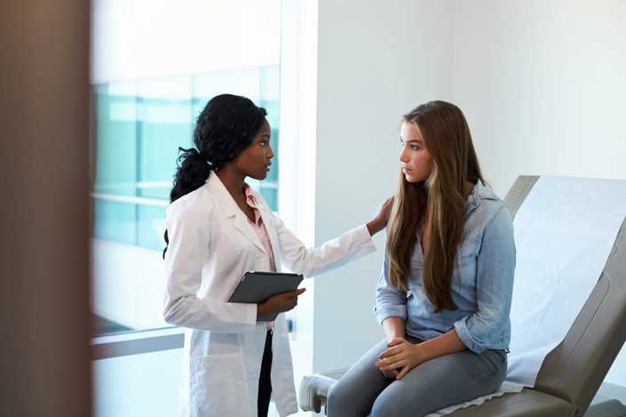 adult patient speaking to a doctor