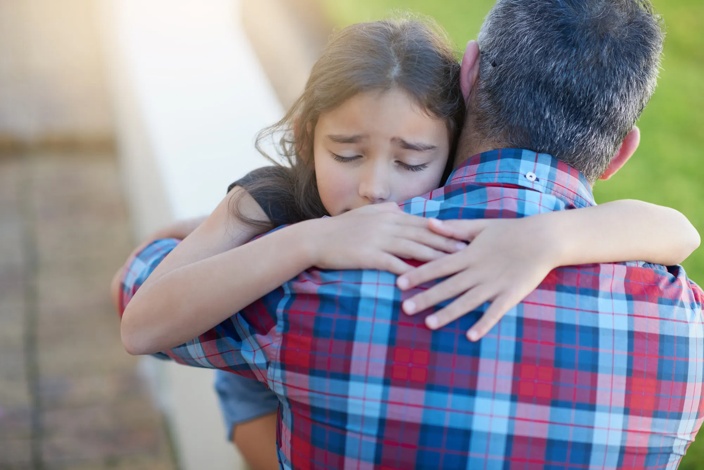 young girl hugging an adult male