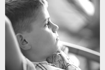 picture side of face of young boy laying down