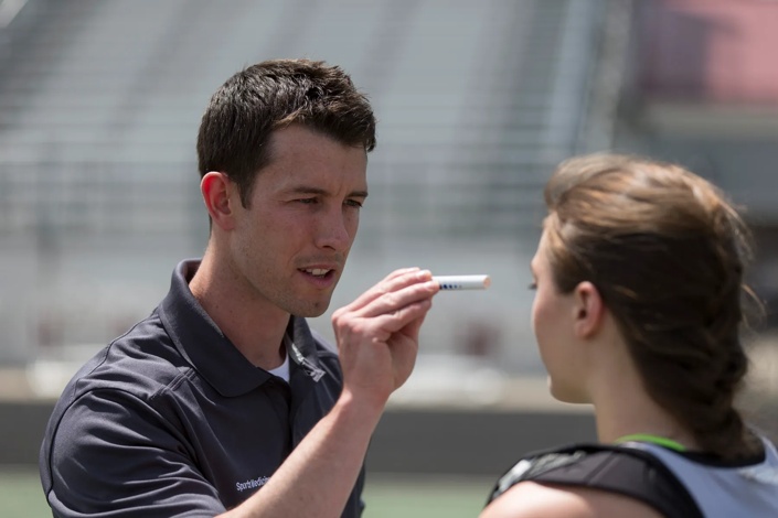 concussion examination being administered to female athlete