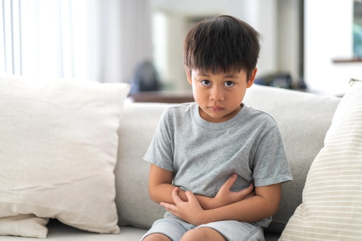 child holding their belly 