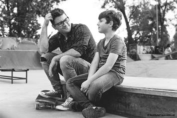 man and boy at skatepark
