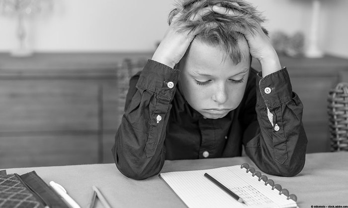 Little boy stressed out by homework