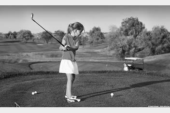 Little girl playing golf