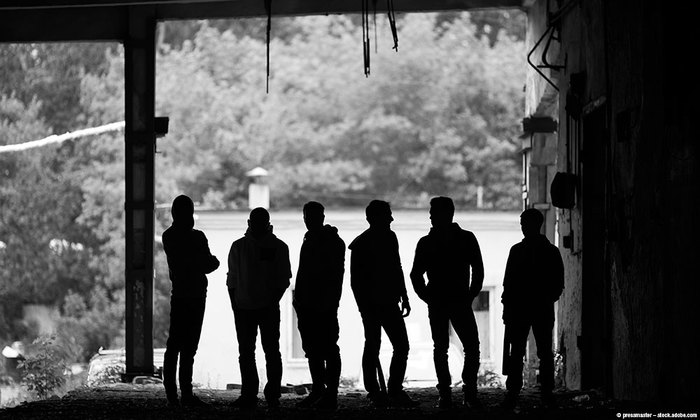 Group of people under a bridge.