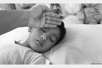 Little boy in bed with the flu.