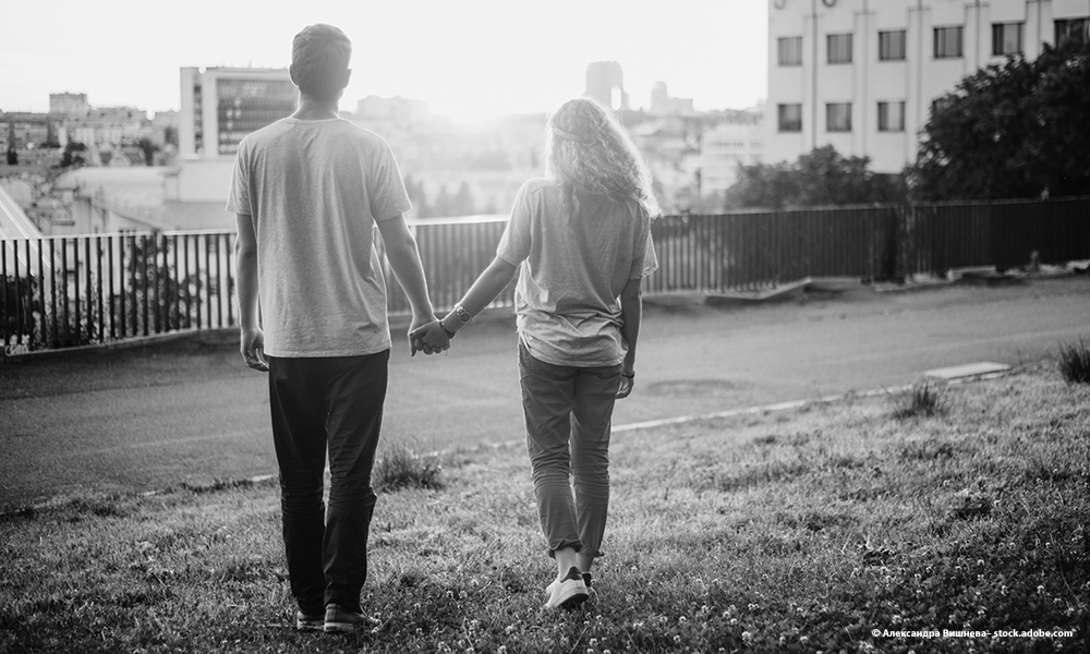 image of male and female teens holding hands