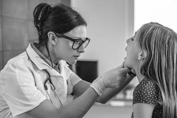 image of a doctor looking at a patient's throat