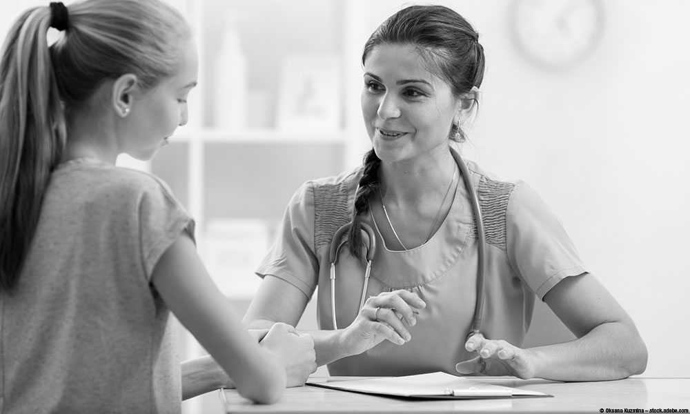 image of adolescent girl talking to a physician