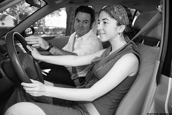 image of a girl driving with her dad