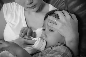 image of a mom holding a sick child