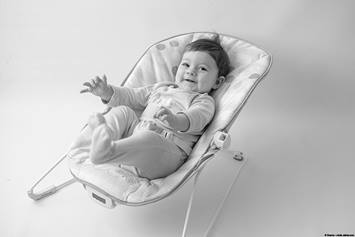 image of a baby girl in a bouncy seat