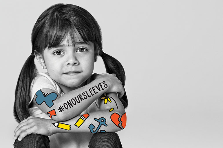 image of a sullen girl with tattoo icons on her arms