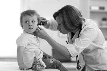 Toddler getting their ear checked by an ENT.