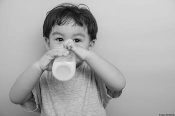 Toddler drinking milk from a bottle