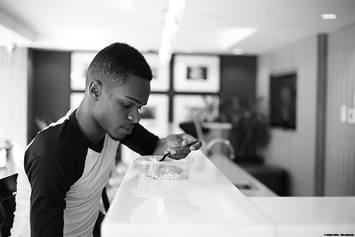 image of teen boy eating a bowl of cereal