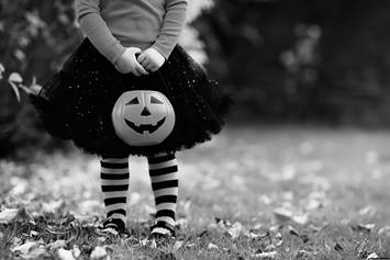 Child wearing Halloween costume, trick-or-treating