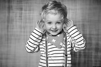 Child holding their ears