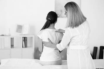 Doctor examining patients lungs