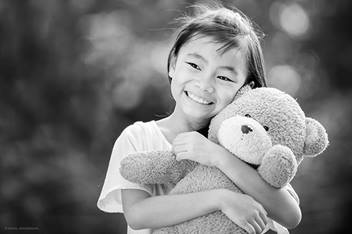 Little girl hugging teddy bear