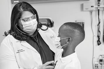Medical professional listening to a patient's heart with a stethoscope