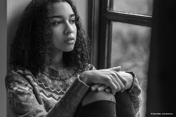 teen sitting with hands folded