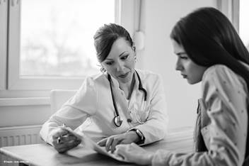 doctor consulting with their teenage patient.