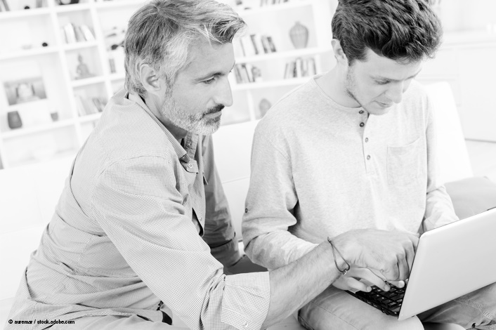 adult helping his teenage child