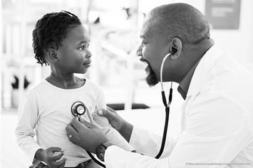 doctor checking a child's lungs with a stethoscope