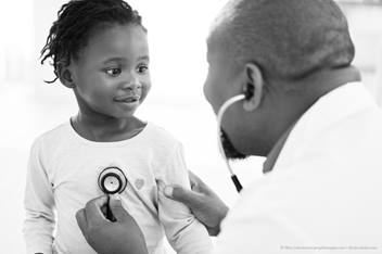 doctor checking patient's heart beat
