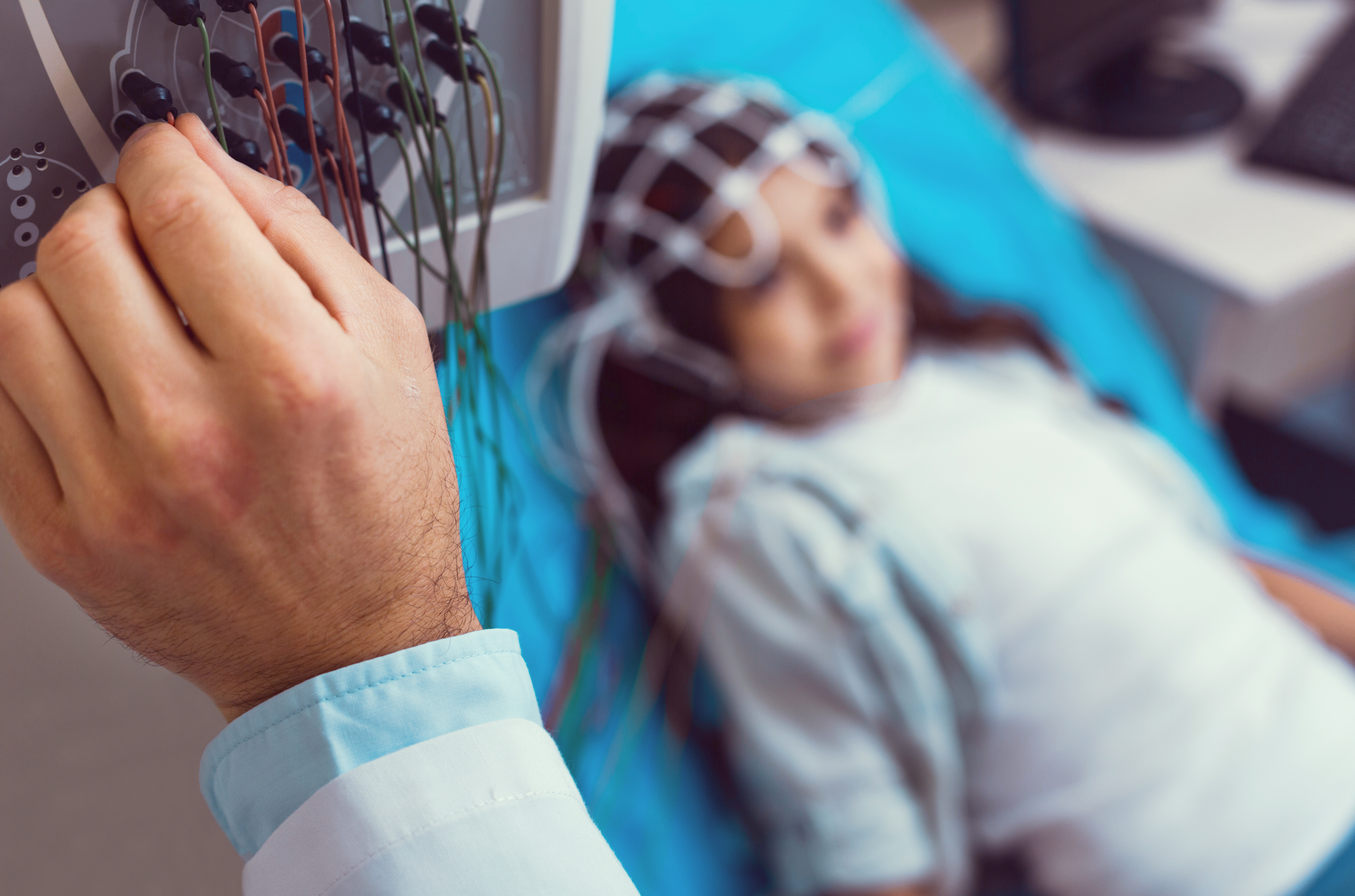 woman connected to a monitor, connected to her head
