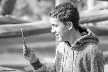 child looking at a phone outside
