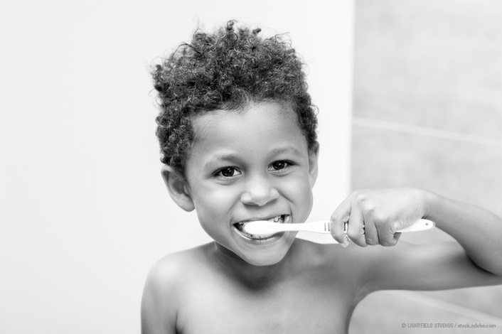 young boy brushing his teeth