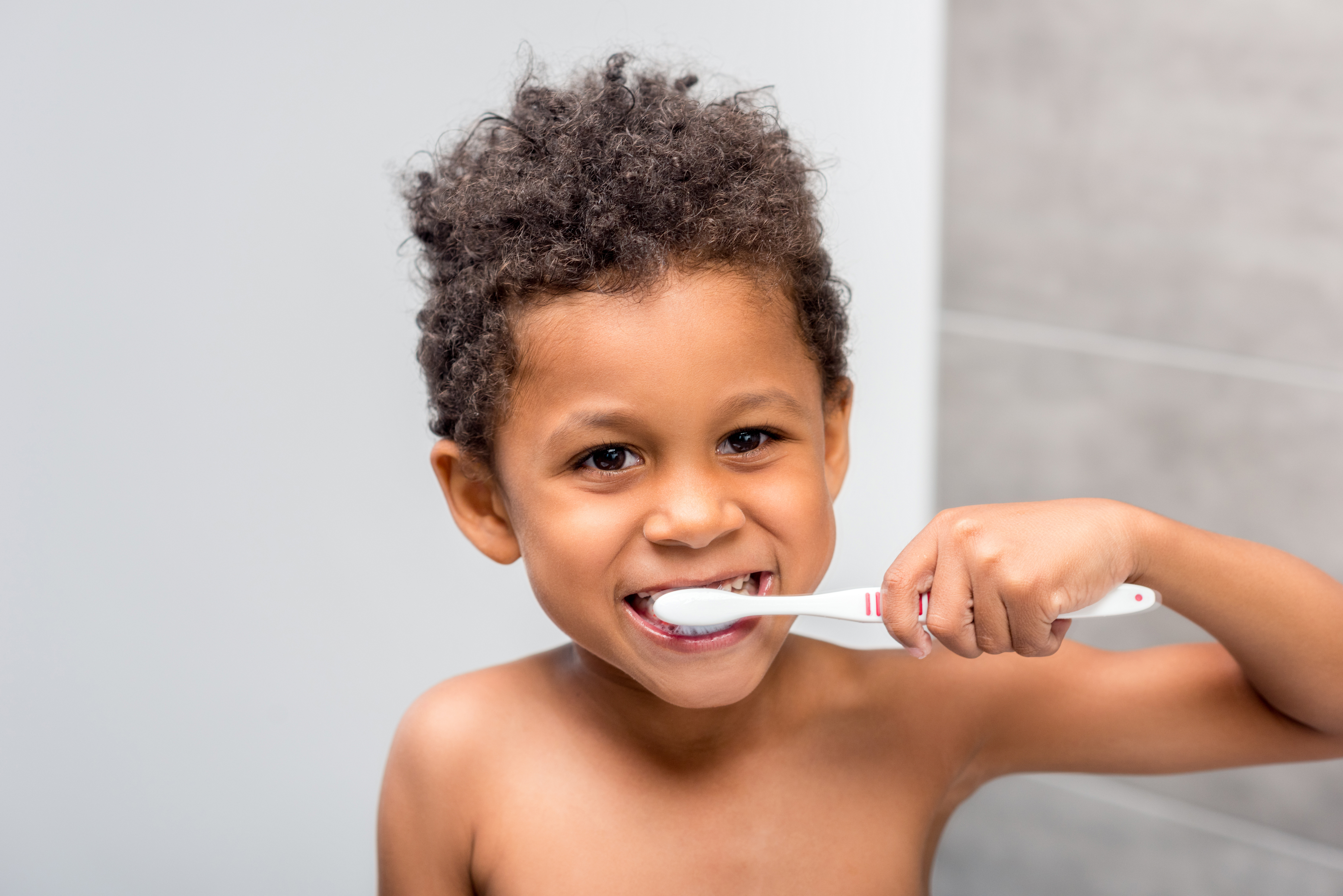 young boy brushing his teeth