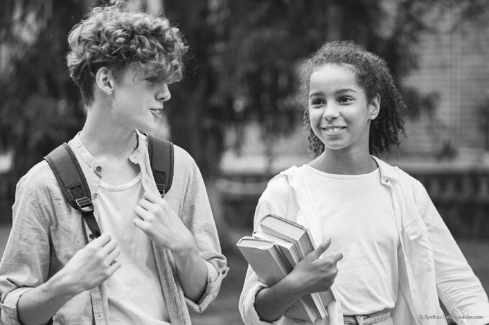 teen boy and teen girl walking and talking together