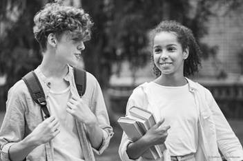 teen boy and teen girl walking and talking together