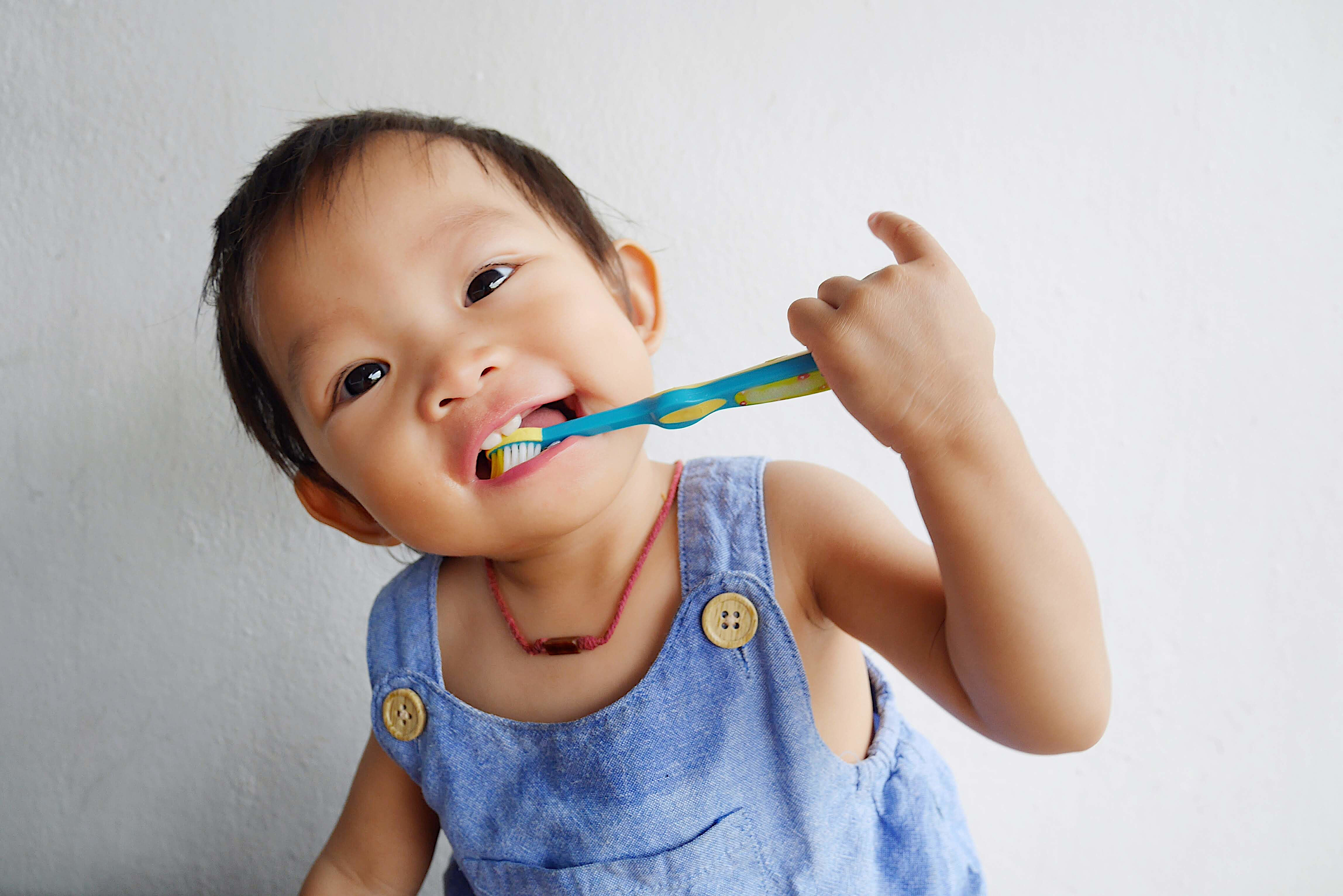young child with a toothbrush in his mouth