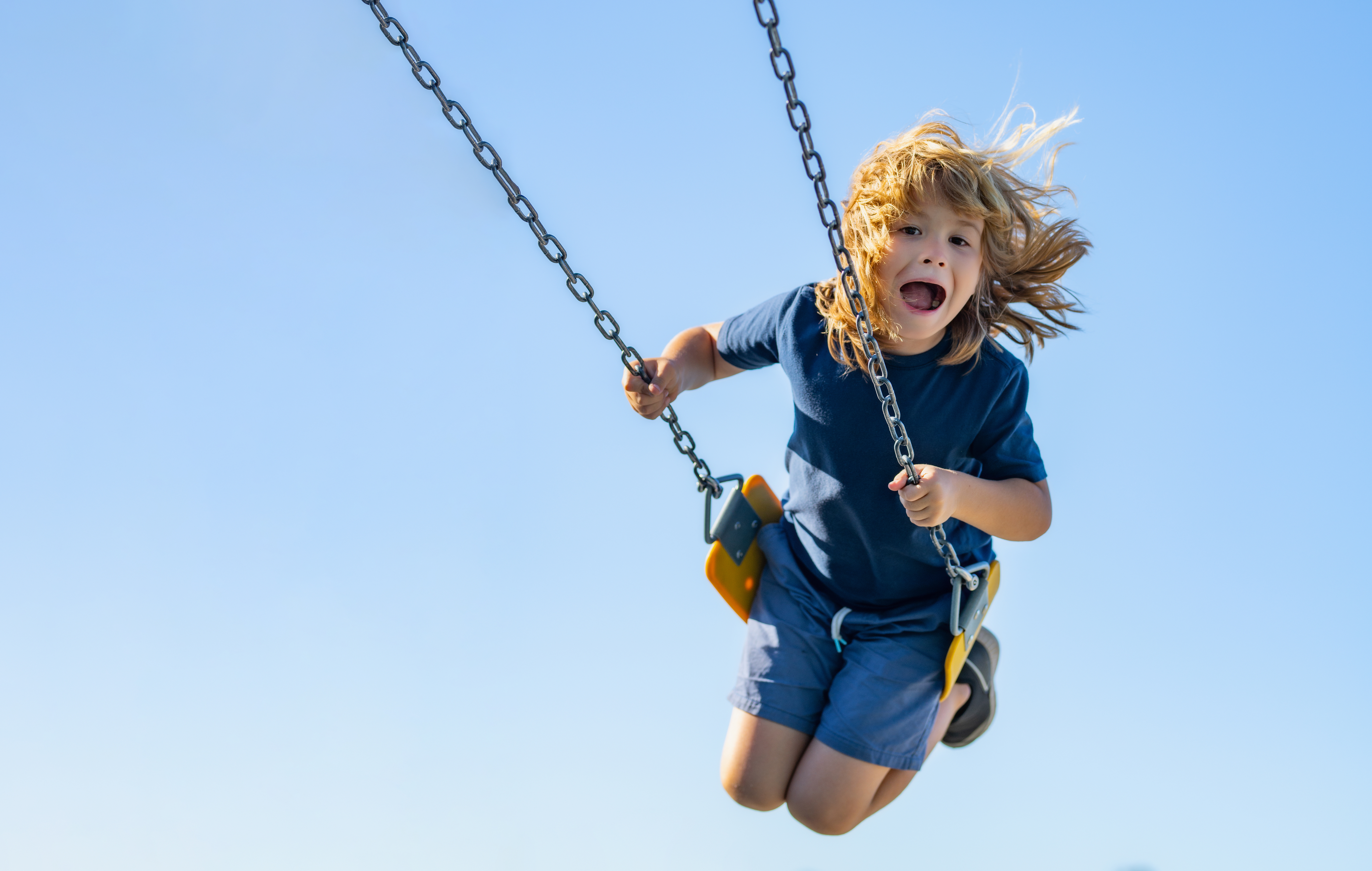child swinging on a swing set