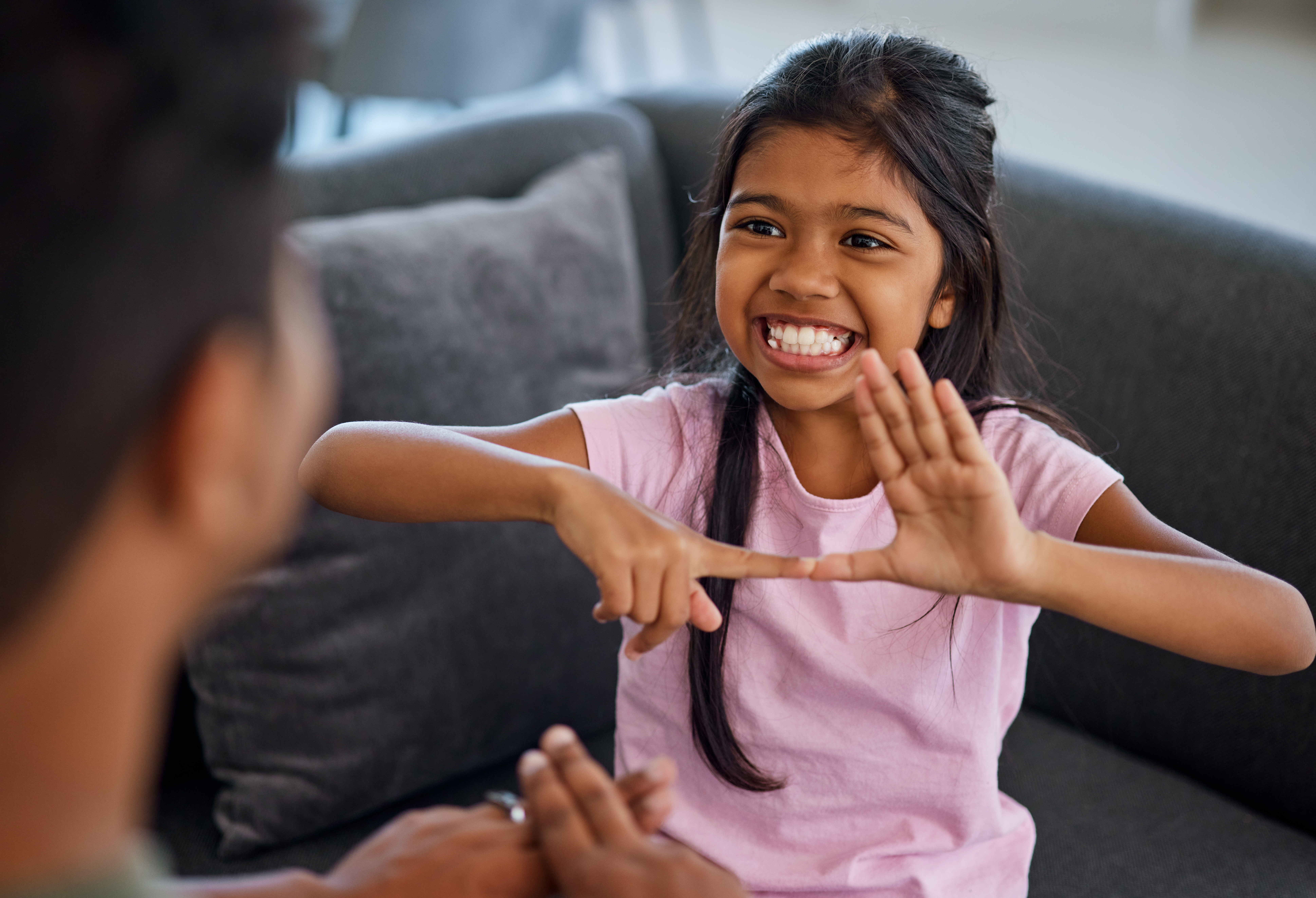 young girl learning American Sign Language