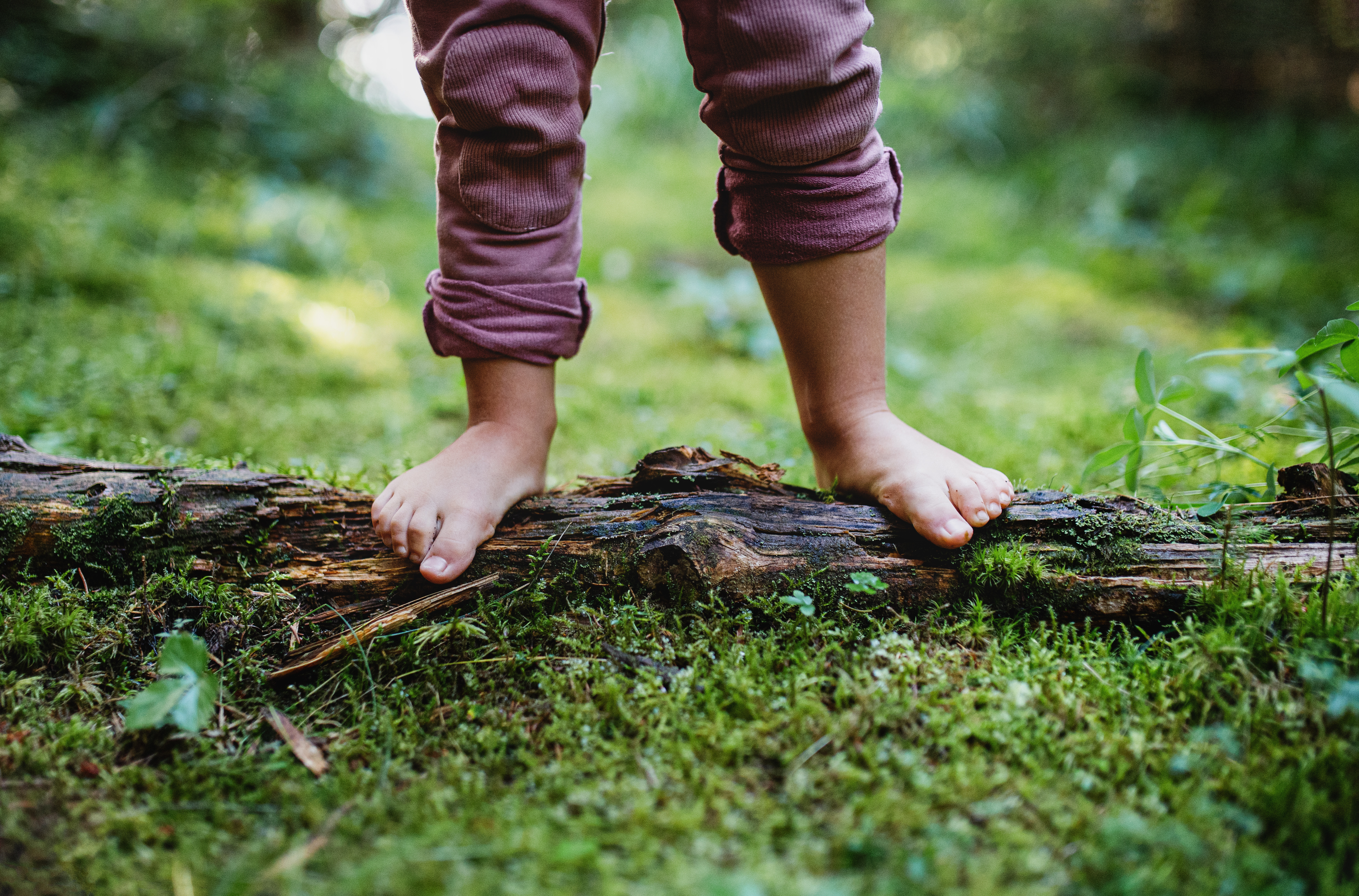 barefoot child standing on mulch