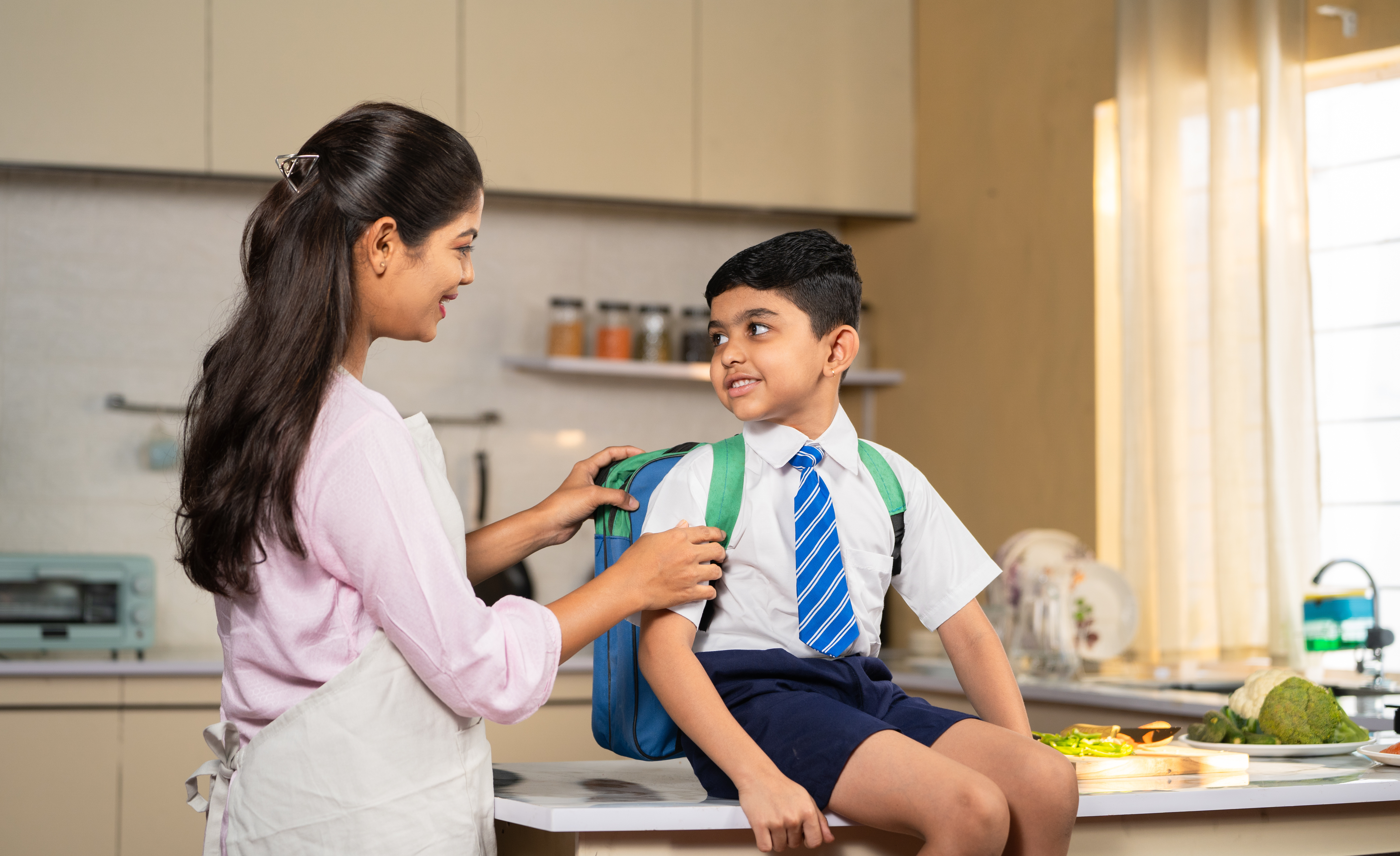 child in a school uniform interacting with the school nurse