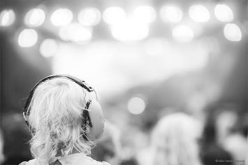 girl with headphones at concert