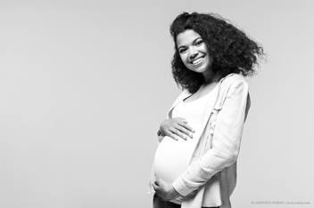 young pregnant woman smiling at the camera